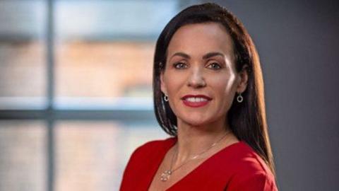 Headshot of Family Lawyer Amanda McAlister wearing a red top and silver jewellery. She is just right of centre and is smiling slightly.