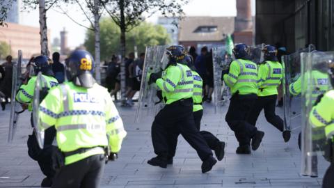 Police charge at protesters in Liverpool