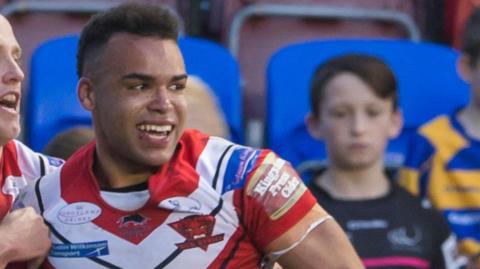 Mason Caton-Brown celebrates scoring a try for Salford Red Devils