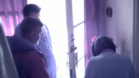 Two men scamming a vulnerable elderly woman