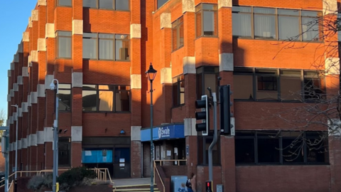 A large red building under clear blue skies.