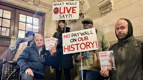 Protestors from 'Save Our Museum' outside Oxford Town Hall in November. They are holding placards opposing the fees.