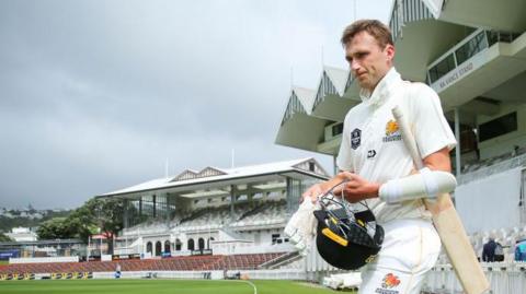 James Hartshorn walks out onto the field to bat for Wellington 