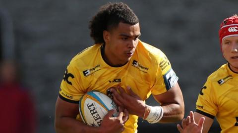 Mackenzie Martin runs with the ball in Dragons' pre-season friendly against Scarlets at Rodney Parade