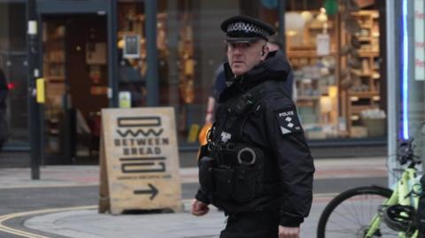 A police officer walking through Exeter City Centre