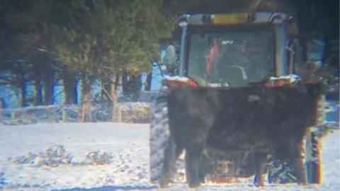 Howard Walters was filmed driving in the snow in a tractor with a child in the cab