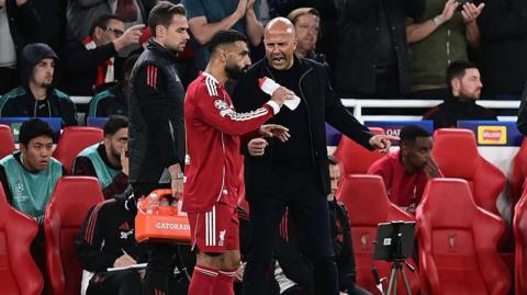 Mohamed Salah and Arne Slot in discussion with one another