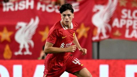 Luke Chambers running with the ball at his feet during a pre-season game for Liverpool in 2024