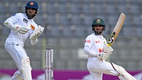Sri Lanka wicketkeeper Kusal Mendis watches Bangladesh batter Mominul Haque hit out in 2024