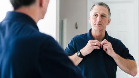 An older man looking in the mirror