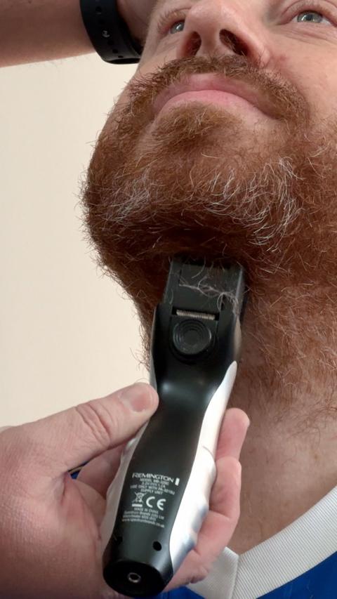 Leicester fan Eli has his beard shaved.