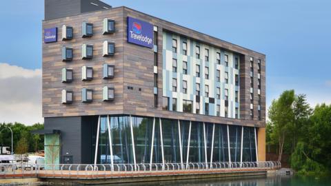 A Travelodge hotel on the side of a lake in Thurrock.