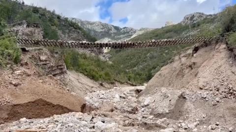 Train track left suspended in the air after landslides