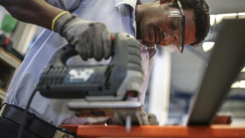 An employee uses a jigsaw to cut a plastic pipe at the Grundfos AS factory in Chennai, India, on Monday, Nov. 27, 2017.