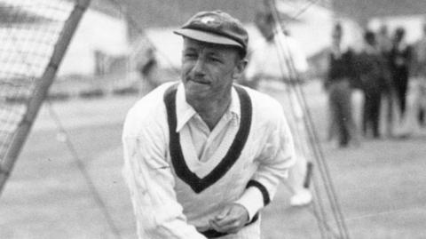 Sir Donald Bradman in action bowling.