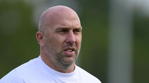 Adam Hinshelwood looks on during his time in charge of York City