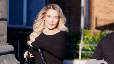 Actress Helen Flanagan arrives at Wirral Magistrates' Court with blonde hair and wearing black