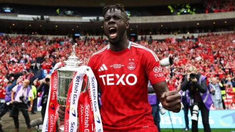 Pape Gueye celebrates with the Scottish Cup at Hampden