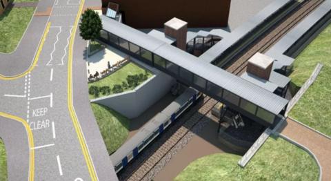 A drawing of a planned railway station seen from the air with a road running above a platform and a footbridge crossing the tracks