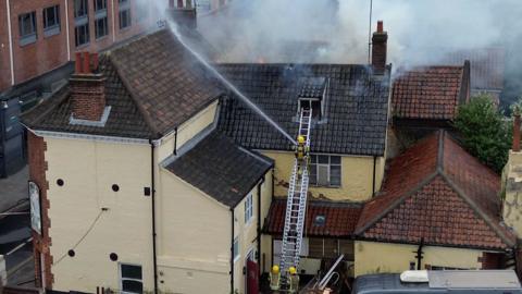 Fire crews tackling a fire in Norwich that forced a college to close