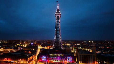 An illuminated Blackpool Tower with a sign highlighting Strictly 2026