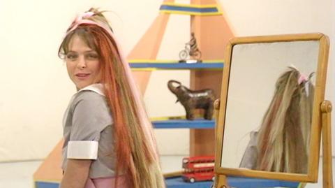 Blue Peter presenter Janet Ellis showing off her multi-coloured synthetic hair extensions.