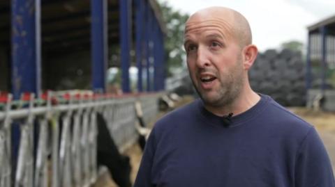 Andrew Gilman wearing blue on his farm