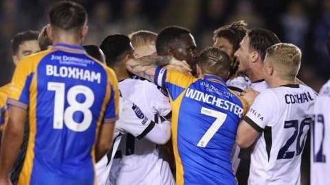 Shrewsbury Town and Birmingham City players square up to each other during a match