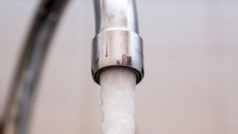 A tap is flowing with water.