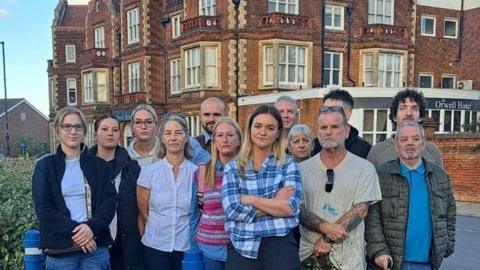 Group of people standing in front of hotel