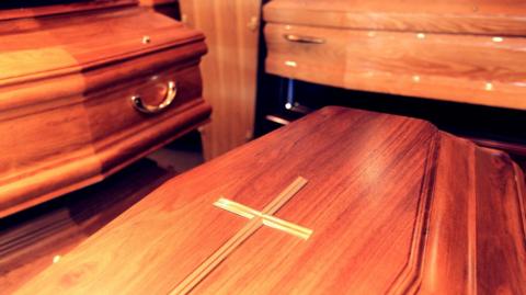 Three wooden coffins stacked up