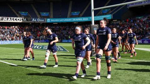 Scotland were beaten heavily by England in front of a record crowd at Murrayfield