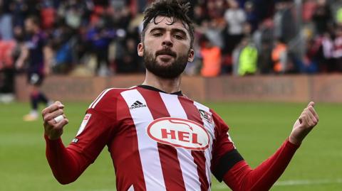 Reece Cole celebrates scoring a goal for Exeter