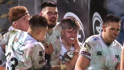 Ospreys players celebrate with Josh Thomas after his dramatic match-winning try