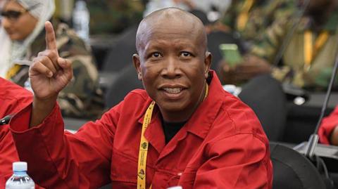 Julius Malema is seen in his signature red overall in parliament