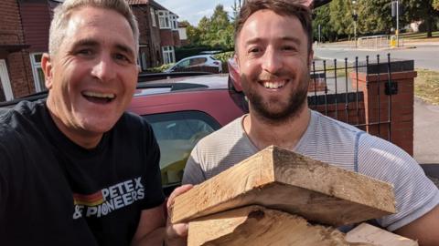The Reverend Matt Woodcock and church member Lee with donated wood