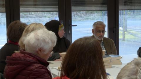 Muslim Association community group sat at a table