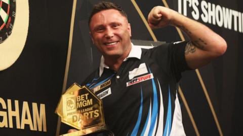 Gerwyn Price poses with a trophy