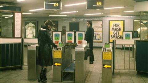 Female passenger passing through an automatic ticket gate, Seven Sisters Underground station, Victoria line, by Dr Heinz Zinram in 1969