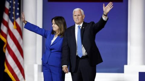Mike Pence and his wife Karen Pence wave on October 28, 2023.