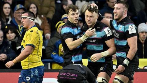 Jack Dempsey celebrates with his Glasgow teammates Jamie Dobie and Matt Fagerson during the Warriors' Champions Cup victory over Clermont Auvergne