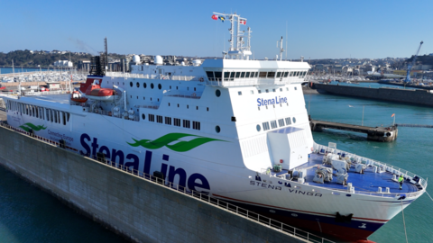 A picture of the Stena Vinga ferry taken from above looking down at the ferry. There is branding on the ferry with a number of houses and boats pictured in the distance.