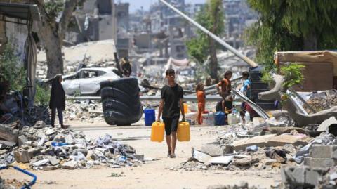 A boy walks through rubble in Gaza