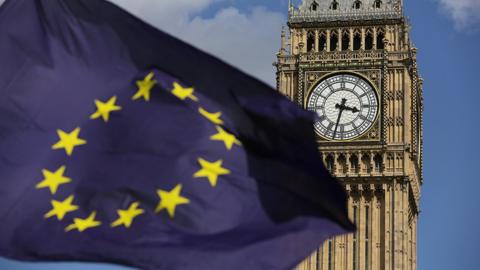 A European Union flag in front of Elizabeth Tower in Westminster