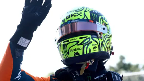 Lando Norris waves after taking pole for the Miami Grand Prix sprint