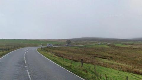 Streetview image of the A54, a single track road curving through bleak moorland landscape