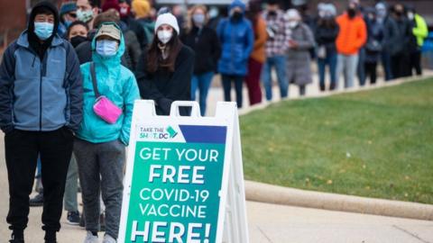 People wait in line at a walk-in vaccination clinic in Washington DC