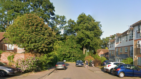 A residential street on a sunny day. 