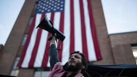 A student hold a megaphone up as he takes part in a pro-Palestinian demonstration at George Washington University in Washington DC