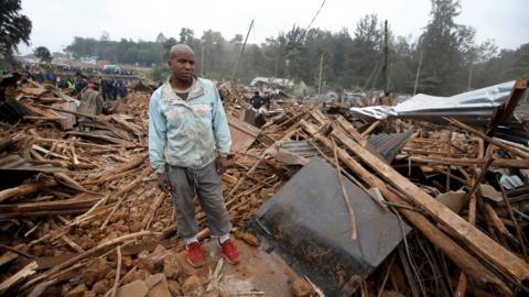 A man stands on the rubbles of his home after bulldozers demolished dozens of houses to make way for a new road in the Kibera slum in Nairobi, Kenya, July 23, 2018